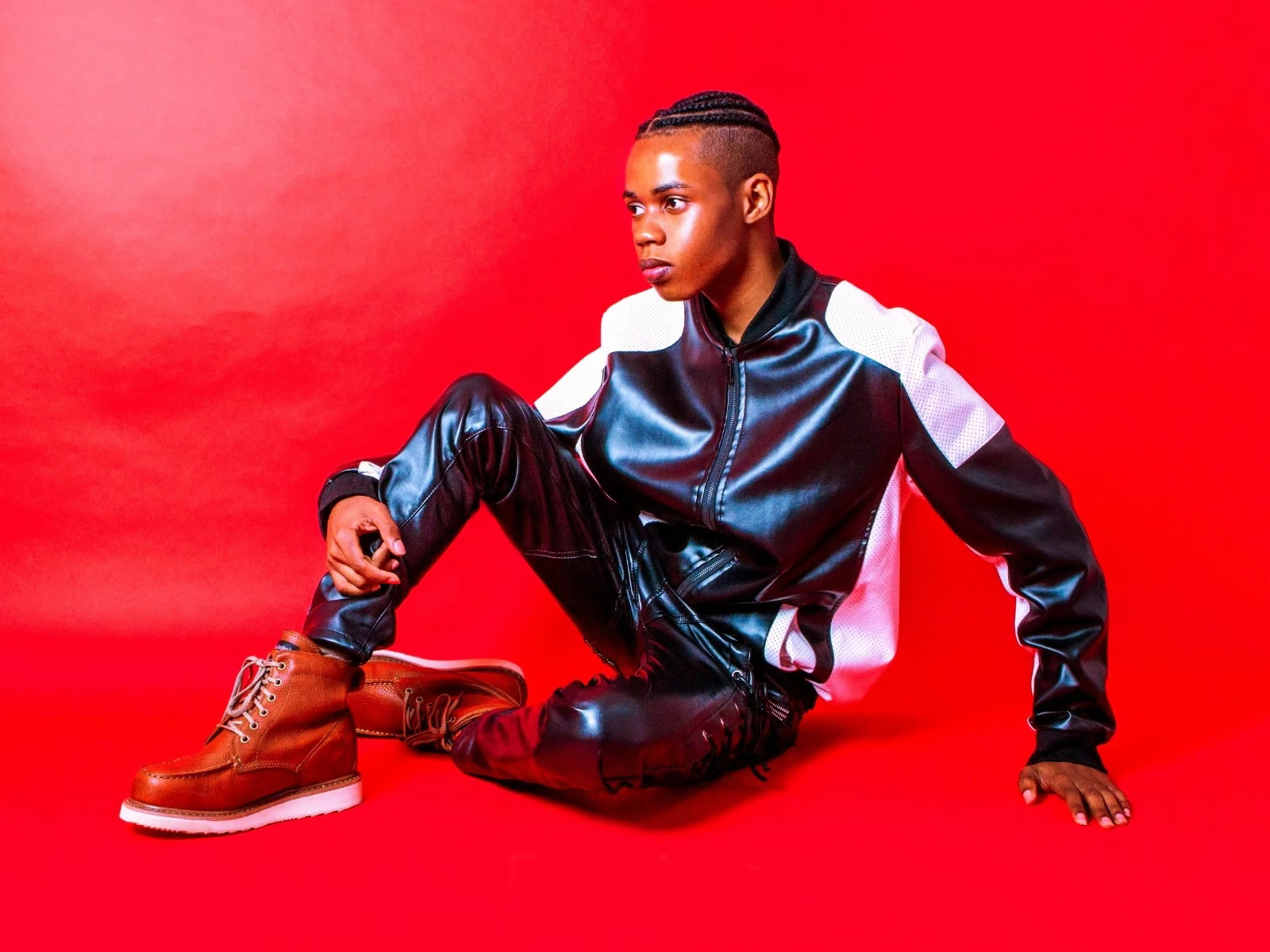 Shilay photoshoot with red background leather outfit